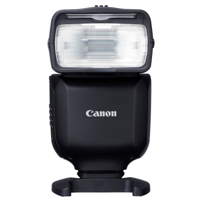 Flash fotográfico Canon preto com lente grande e base.