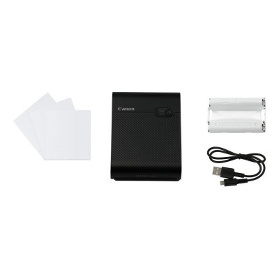 Impressora fotográfica portátil Canon preta com acessórios sobre fundo branco