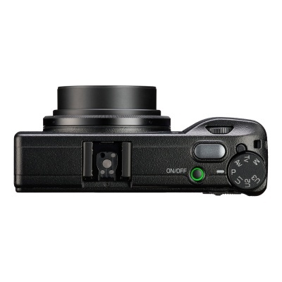 Câmera digital compacta preta vista de cima com lente telescópica e seletor de modos.