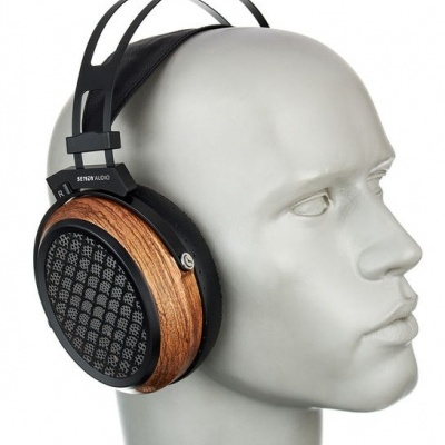 Headphones with wooden ear cups and black headband on a white mannequin head