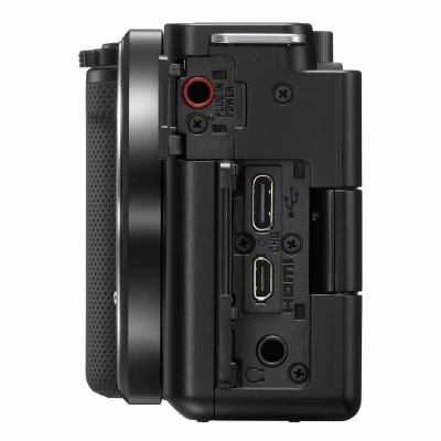 Lado de uma câmara fotográfica preta com portas HDMI, USB e DC IN POWER