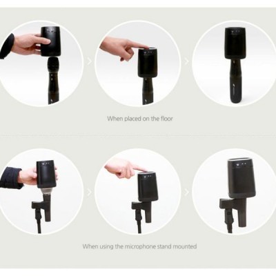 Dispositivo preto compacto para microfone com controle tátil, usado no chão ou em suporte.