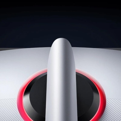 dispositivo branco com anel luminoso vermelho e componente central vertical sobre fundo escuro