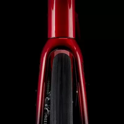 Parte frontal de bicicleta vermelha com pneu preto sobre fundo negro