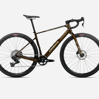 Bicicleta Orbea castanha escura com detalhes dourados e pneus pretos