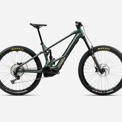 Bicicleta elétrica de montanha Cannondale verde escuro com pneus Maxxis em fundo branco