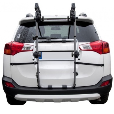 Suporte de bicicletas fixado na traseira de um veículo SUV branco.