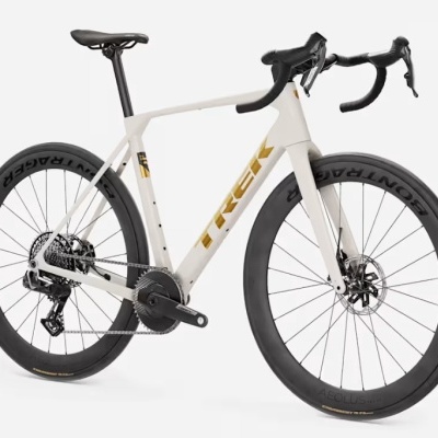 Bicicleta de estrada branca e dourada com rodas pretas e selim preto