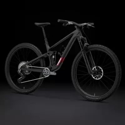 Bicicleta de montanha preta com detalhes vermelhos em fundo preto