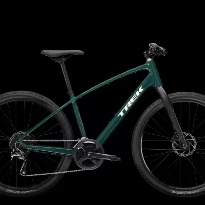 Bicicleta Trek verde escuro com pneus pretos largos e logo branco
