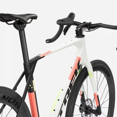 Bicicleta de estrada branca, coral e preta com rodas Bontrager e guiador curvo preto