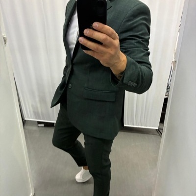 Fato masculino verde-escuro risca de giz com blazer e calças ajustadas, camiseta branca e sapatilhas brancas