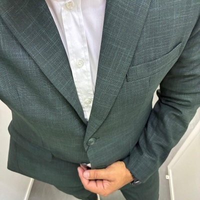 Homem vestido com fato cinzento risca de giz e camisa branca