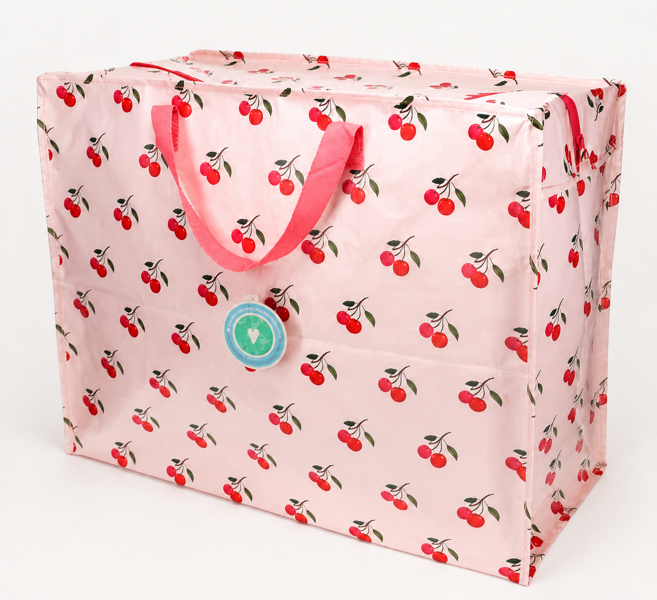 Mala rosa com padrão de cerejas vermelhas e alças rosas