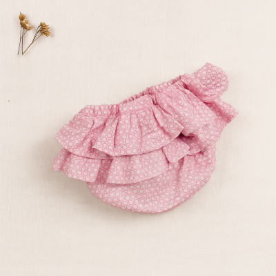 Cueca ou tapa-fraldas rosa claro com padrão de círculos e babados