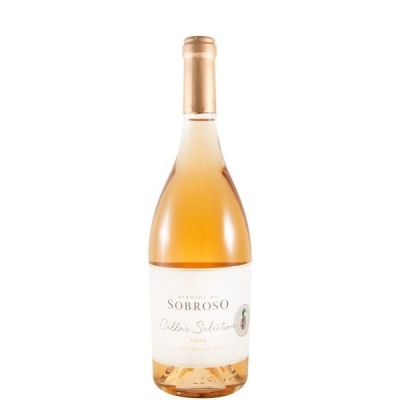 Garrafa de vinho rosé com rótulo branco e rolha dourada