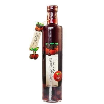 Garrafa de licor com cerejas e rótulo branco com cerejas e texto