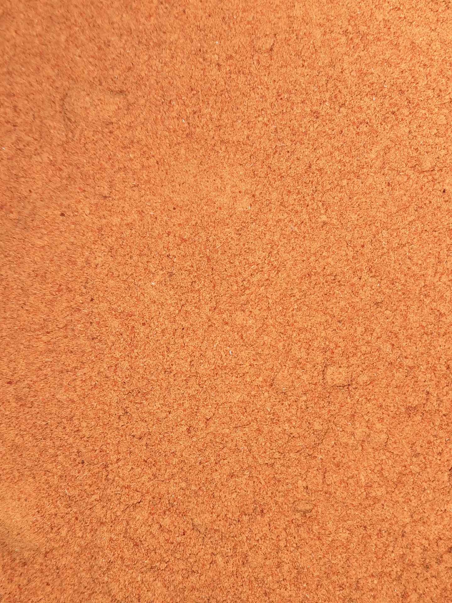 Superfície granulada laranja-queimado em textura fina