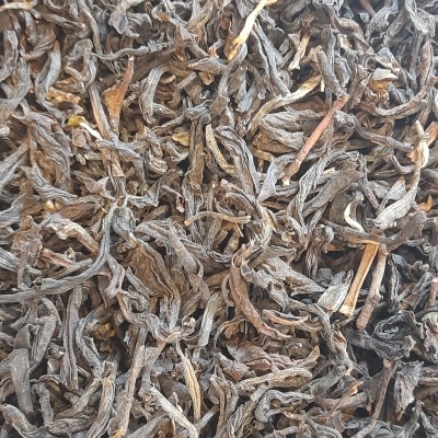 Chá preto solto com folhas enroladas castanho e preto