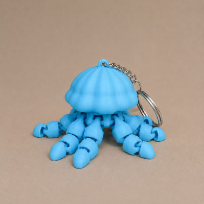 Chaveiro azul em forma de medusa com tentáculos articulados