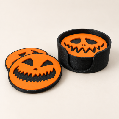 Bases para copos de Halloween em silicone preto e laranja com design de abóbora.