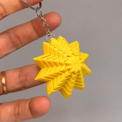 Chaveiro amarelo em forma de estrela tridimensional em plástico