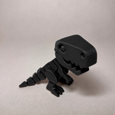 Figura de dinossauro preto em plástico com articulações, em fundo claro