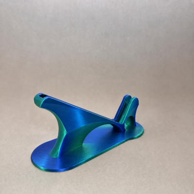 Estrutura metálica azul e verde com base oval sobre superfície cinza