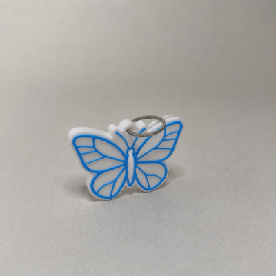 Chaveiro plástico branco em forma de borboleta com detalhes azuis