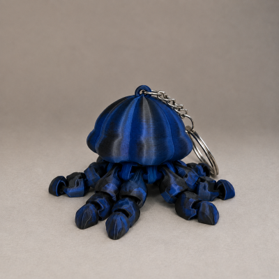 Chaveiro de polvo azul e preto com tentáculos articulados e anilha metálica