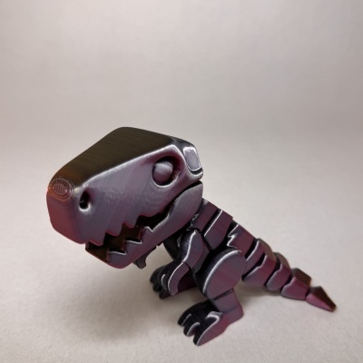 Figura plástica preta de dinossauro T-Rex sobre fundo branco