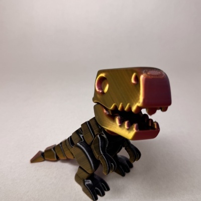 Miniatura de dinossauro T-Rex em plástico dourado e rosa metálico