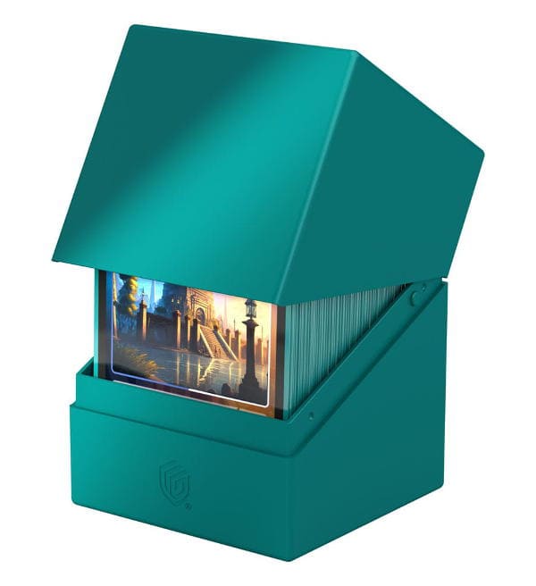 Caixa verde-azulada de cartas de jogo com tampa aberta mostrando cartas decorativas