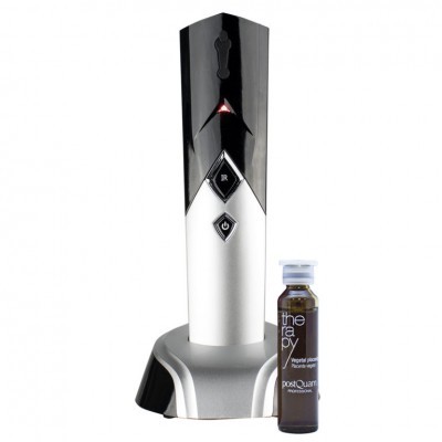 Dispositivo branco e preto com botões em diamante numa base cinzenta junto a um pequeno frasco castanho rotulado