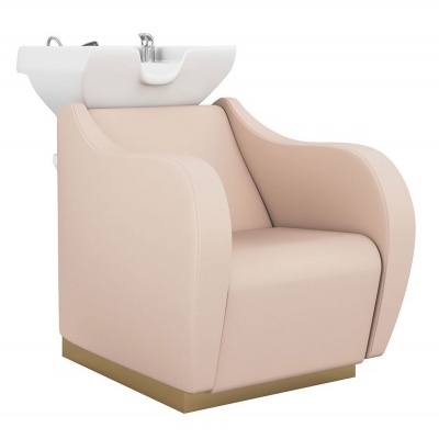 Cadeira de lavagem de cabelo rosa claro com lavatório branco e torneira