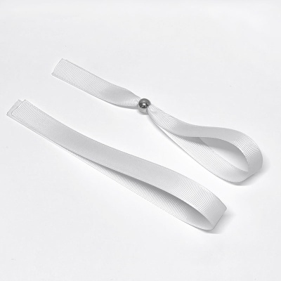 Duas fitas brancas texturizadas com esfera metálica prateada numa sobre fundo branco