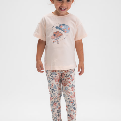 Criança com t-shirt rosa claro com estampa de chapéus e calças florais coloridas