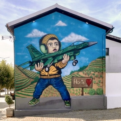 Mural colorido de criança com avião e paisagem no exterior