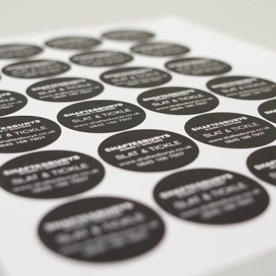 Folha com autocolantes redondos pretos com texto branco