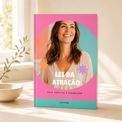 Livro colorido com capa rosa e azul, retrato de mulher sorridente, texto sobre Lei da Atração.