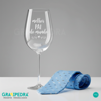 Copo de vidro com texto e gravata azul claro com padrões pequenos