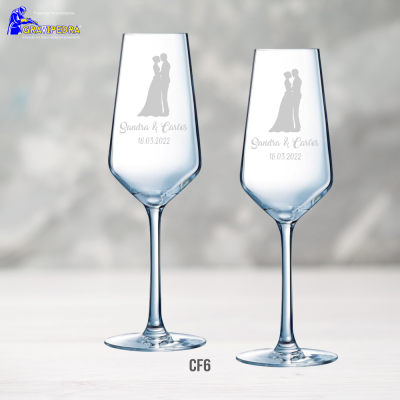 Duas taças de champanhe gravadas com textos e silhuetas de casal