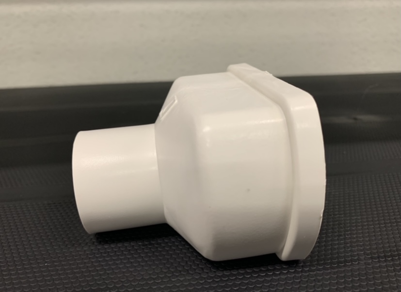 Topo con descarga para Perfil Producción Conector branco de tubo em plástico sobre superfície preta