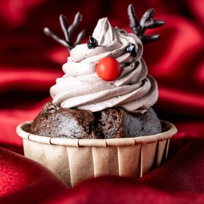 Cupcake decorado como rena com chifres de chocolate e nariz vermelho