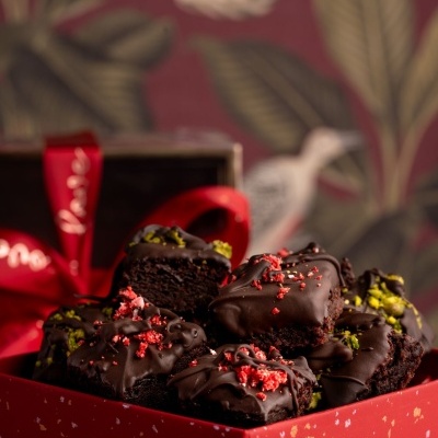 Bolos de chocolate decorados em caixa vermelha com fundo floral