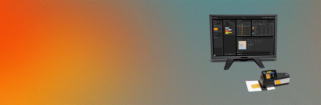 Equipamento de leitura digital com ecrã e base com etiquetas coloridas numa mesa com fundo gradiente laranja e cinzento