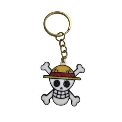 Porta-chaves com pendente de caveira com chapéu amarelo e faixa vermelha