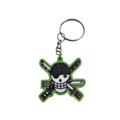 Porta-chaves com pendente de caveira com espadas cruzadas e borda verde
