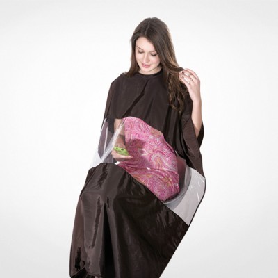 Capa preta de corte de cabelo com painel transparente usada por mulher sentada