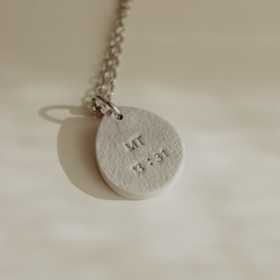 Colar com pendente oval branco texturizado e corrente prateada com gravação MT 13:31